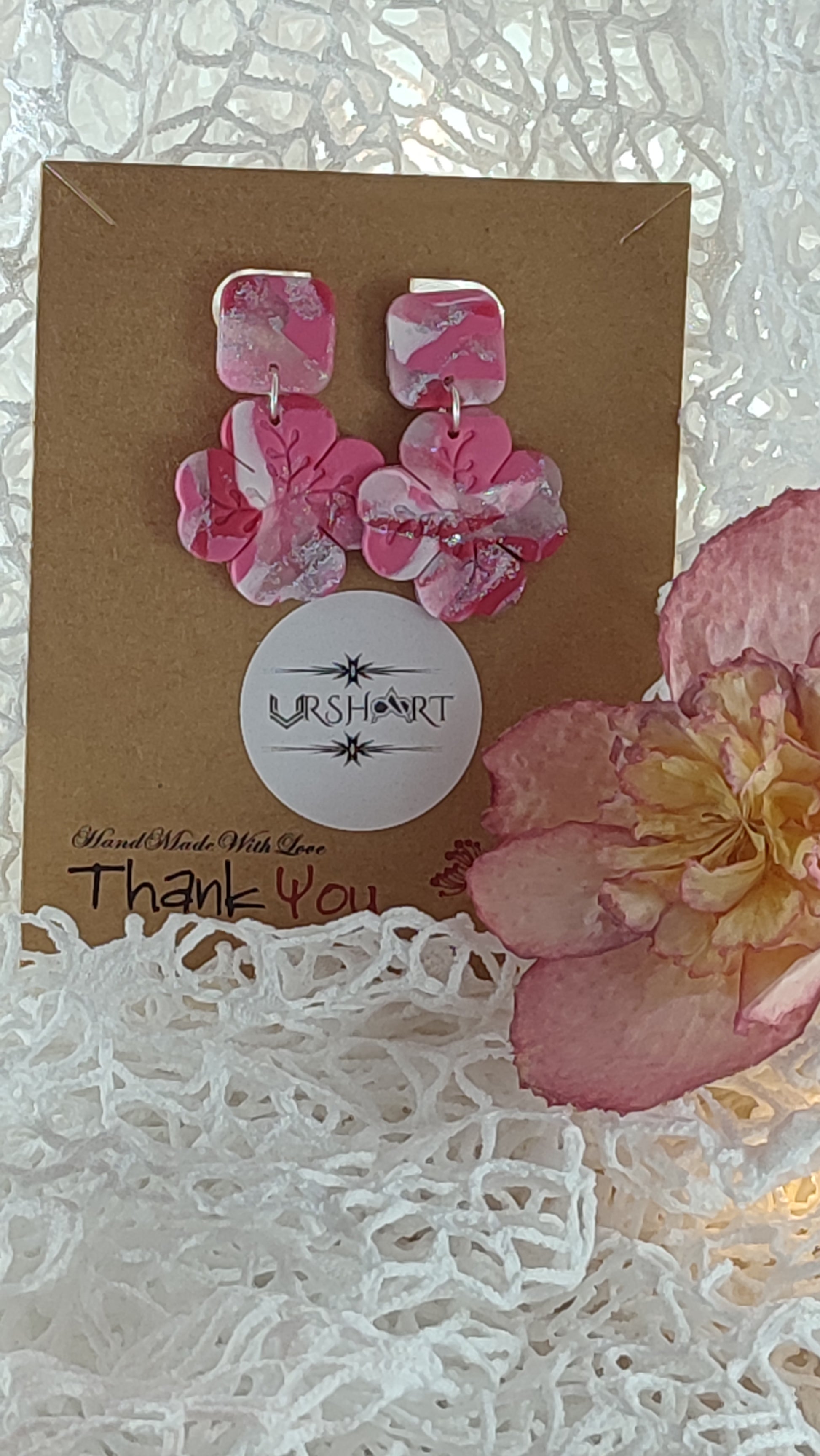 Handmade polymer clay earrings featuring a beautiful combination of pink, silver, and white colors. These lightweight, dangle earrings showcase a unique, modern design perfect for any occasion.