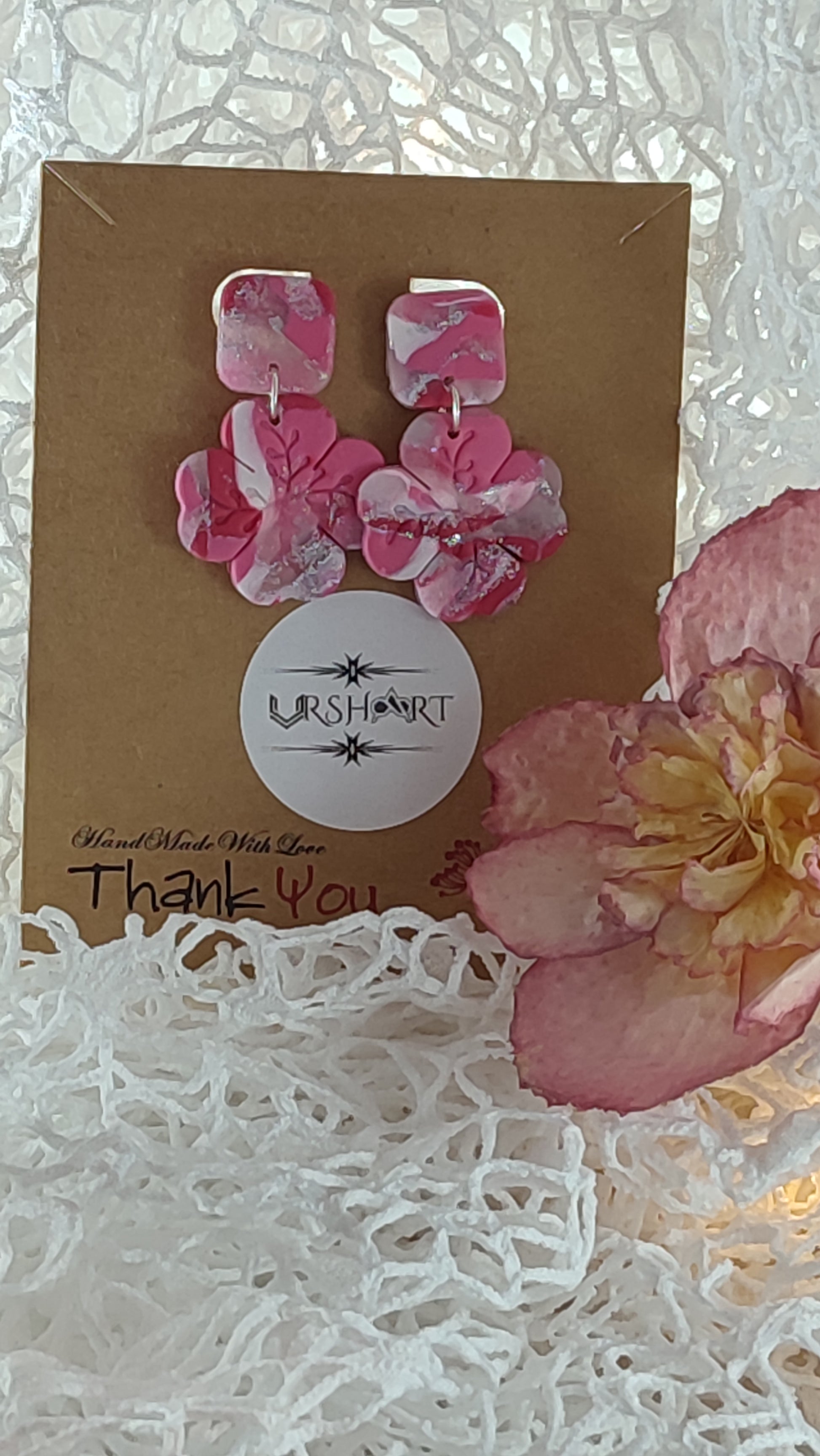 Handmade polymer clay earrings featuring a beautiful combination of pink, silver, and white colors. These lightweight, dangle earrings showcase a unique, modern design perfect for any occasion.