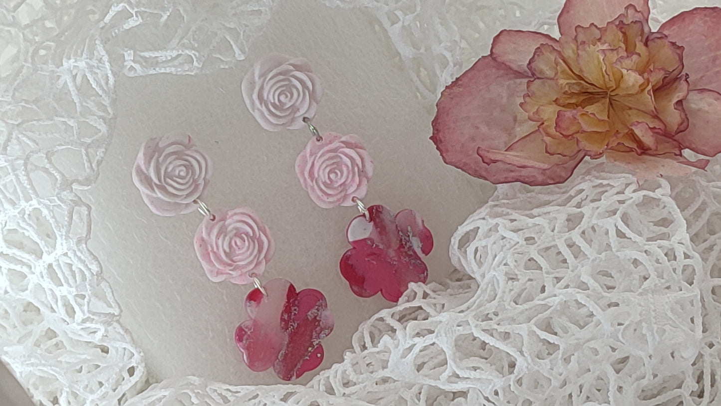 Handcrafted polymer clay earrings featuring a beautiful combination of pink, silver, and white colors. The unique design showcases a playful mix of shapes and textures, perfect for adding a touch of elegance to any outfit.