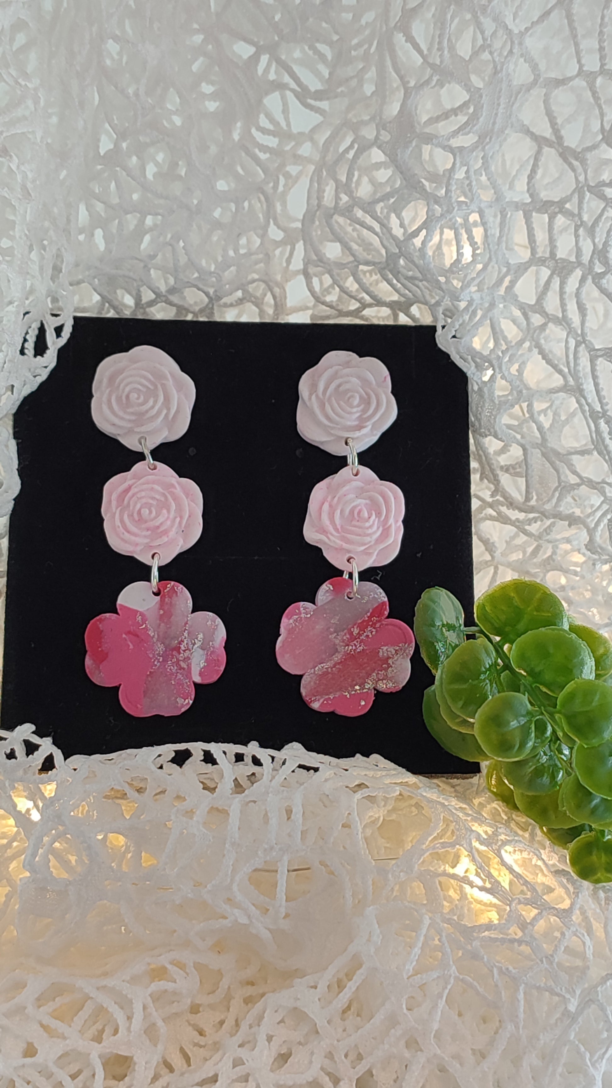 Handmade polymer clay earrings featuring a beautiful combination of pink, silver, and white colors. These lightweight, dangle earrings showcase a unique, modern design perfect for any occasion.