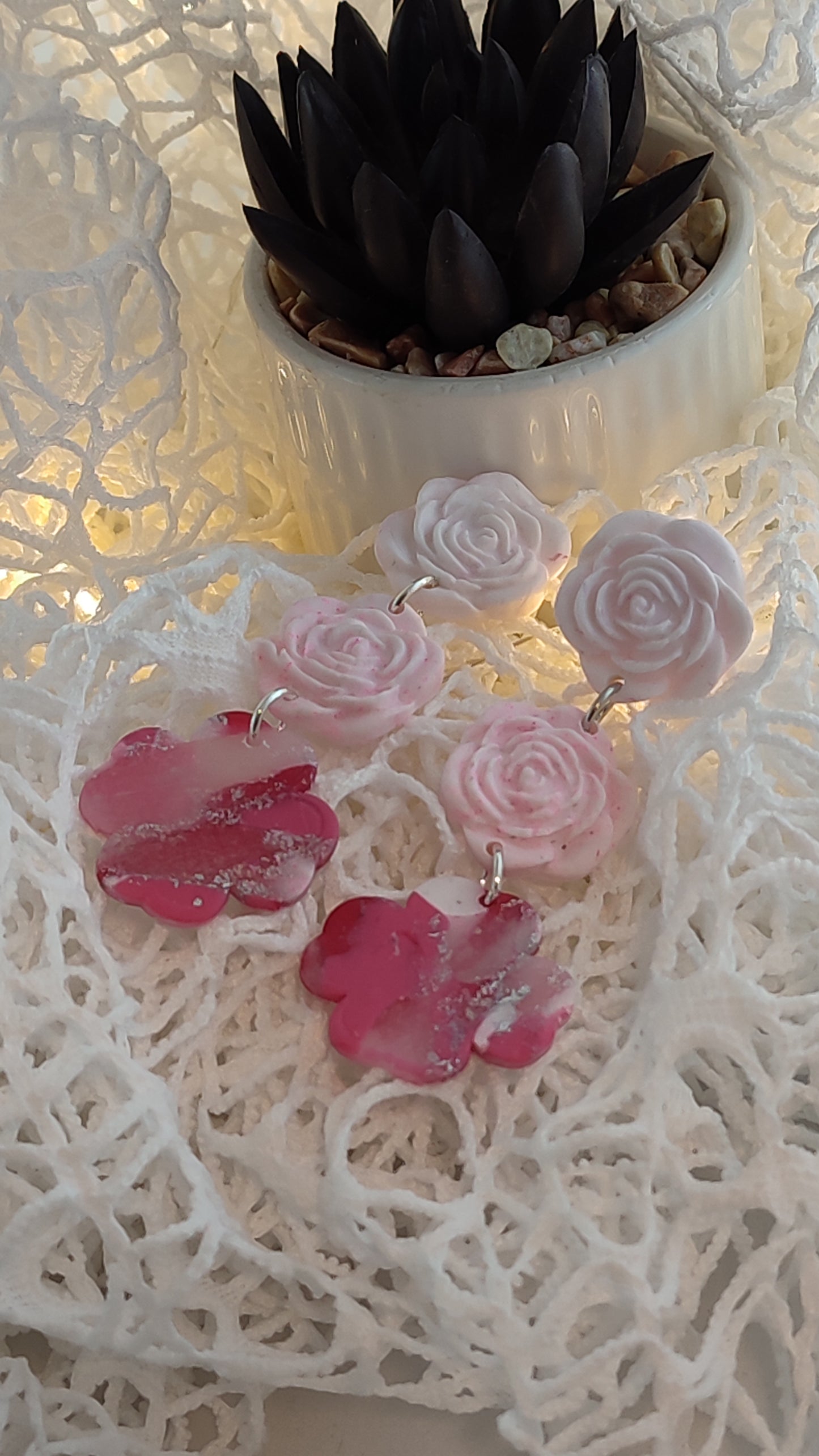 Handcrafted polymer clay earrings featuring a beautiful combination of pink, silver, and white colors. The unique design showcases a playful mix of shapes and textures, perfect for adding a touch of elegance to any outfit.