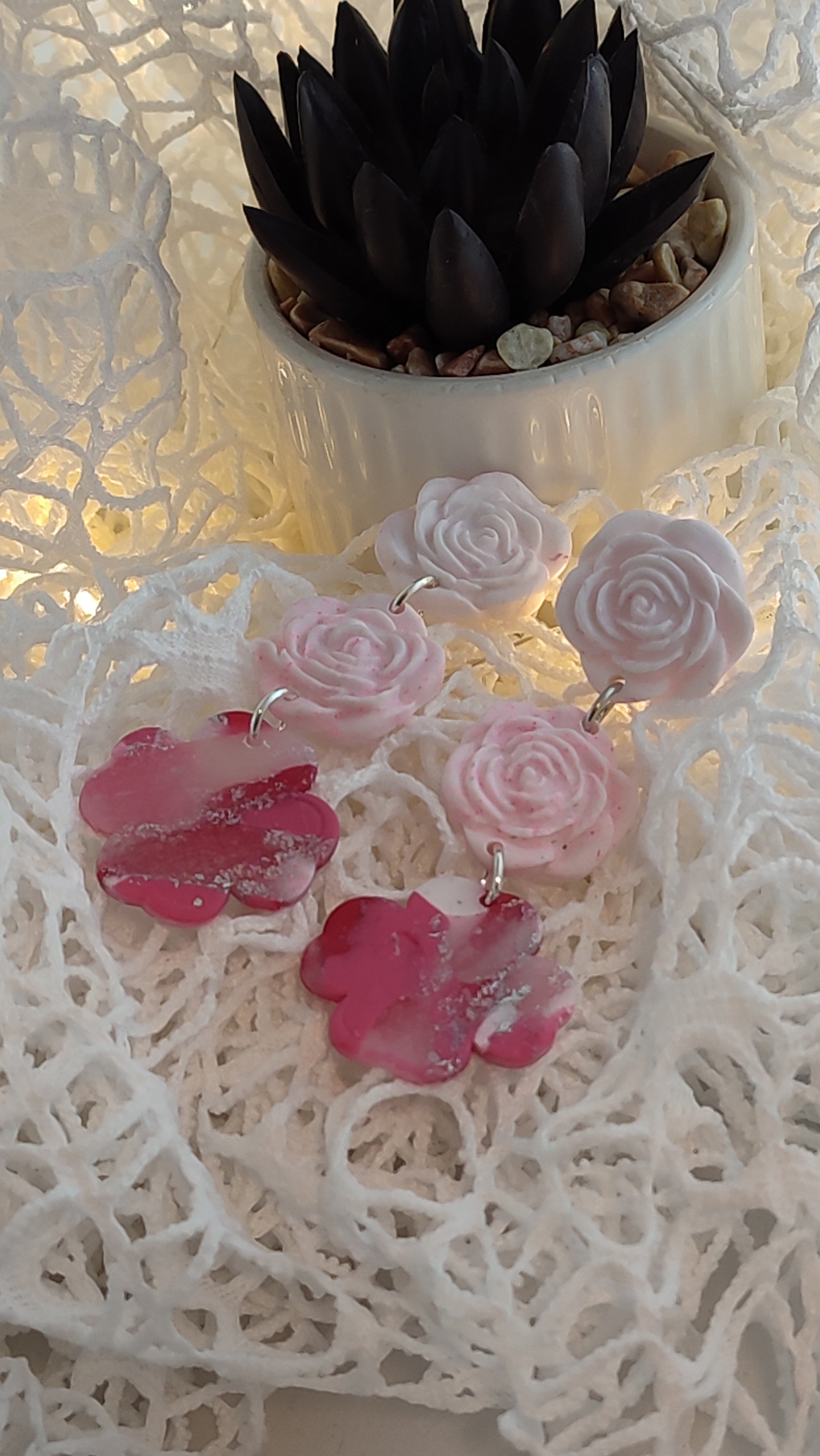 Handcrafted polymer clay earrings featuring a beautiful combination of pink, silver, and white colors. The unique design showcases a playful mix of shapes and textures, perfect for adding a touch of elegance to any outfit.